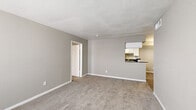 Located at 2500 E James Ave in Baytown, TX, this single-story, 3-bedroom, 4-bathroom home offers a practical and well-organized layout. The living area features soft carpet flooring, neutral gray walls, and a textured ceiling, creating a bright and understated atmosphere. A built-in shelving unit adds a functional touch to the living space. The kitchen is efficiently designed with white cabinetry, dark countertops, wood-look vinyl flooring, and a skylight that brings in natural light. It also includes in-unit laundry hookups, a gas range, dishwasher, and a pass-through opening to the living area. Each of the three bedrooms is carpeted with neutral tones and offers generous closet space — including walk-in closets with built-in shelving and hanging rods. The primary bedroom provides a comfortable footprint with direct access to its own closet. The four bathrooms are clean and straightforward, each featuring tiled tub-shower combinations with chrome fixtures. A central hallway connects the rooms, ensuring an efficient flow throughout the home. The overall aesthetic is clean, neutral, and move-in ready.