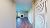 This 810 square foot apartment in the Highlands of Marin offers a blend of comfort and style. The open-concept living area is anchored by a sleek fireplace and boasts large windows that flood the space with natural light, providing scenic views of the surroundings. The kitchen is a highlight, featuring light wood cabinetry, stainless steel appliances, and a striking blue backsplash that adds a pop of color.

Both bedrooms are generously sized, with the primary bedroom measuring 150 square feet. The bathrooms are well-appointed, one featuring a shower-tub combination and the other a standalone shower. Hardwood floors run throughout the apartment, lending warmth and elegance to the space.

Storage is ample, with built-in closets in the bedrooms and additional storage solutions. The apartment's neutral color palette provides a versatile backdrop for various decor styles. Located in San Rafael, this property combines modern living with the charm of Marin County, offering a perfect balance of comfort and convenience.