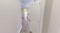 Located at 1703 Island Home Ave in Knoxville, Tennessee, this single-story, 4-bedroom, 3-bathroom home offers a well-organized layout designed for comfortable everyday living. The interior is unified by light wood-look flooring throughout the main living areas and hallway, complemented by crisp white walls and clean crown molding details.

The open-concept living area connects seamlessly to the kitchen via a peninsula counter with granite countertops, ideal for casual dining or entertaining. The kitchen is well-appointed with rich dark wood cabinetry, granite countertops, and a full suite of stainless steel appliances, including a refrigerator, range, and built-in microwave. Pendant lighting above the peninsula adds a polished finishing touch.

The bedrooms feature neutral carpet, ceiling fans, and windows that allow natural light to filter in. Several bedrooms include dedicated closets with wire shelving systems for organized storage. The bathrooms echo the home's consistent design language, featuring wood-look flooring, dark vanity cabinetry, granite countertops, and tiled tub-shower combinations.

A dedicated laundry room accommodates a full-size washer and dryer with overhead wire shelving. The living room offers access to an outdoor area through a glass-paneled door, extending the sense of space.