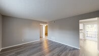 Located at 100 Morrow Rd in Forest Park, GA, this single-story home offers four bedrooms and one bathroom across a efficiently arranged floor plan. The living room features neutral gray walls, wood-style plank flooring, and a textured ceiling, with a large window that allows natural light to fill the space. The updated kitchen is a standout feature, boasting white shaker cabinetry, granite-style countertops, a marble-look tile backsplash, and stainless steel appliances including a gas range, refrigerator, and built-in microwave, complemented by light tile flooring. The bedrooms are carpeted and each include ceiling fans with lighting and windows for natural light, providing comfortable, functional spaces. The bathroom features a full tub-shower combo with white subway tile surround and a sliding glass window for ventilation. A dedicated laundry area with an in-unit washer connection adds practical convenience. Throughout the home, a consistent neutral gray palette and clean white trim create a cohesive, move-in-ready aesthetic. The single-floor layout ensures easy accessibility and efficient use of space.