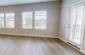 This contemporary 1270 square foot apartment in Kissimmee, Florida offers a harmonious blend of comfort and style. The single-floor layout encompasses three bedrooms, including a generous 230 square foot primary bedroom, and two full bathrooms. The heart of the home is an open-concept living area, seamlessly connecting the kitchen and living room.

The modern kitchen is a standout feature, boasting white cabinetry, stainless steel appliances, and a substantial island with a light-colored countertop. Pendant lighting adds a touch of elegance, while the adjoining dining area creates a perfect space for entertaining.

Throughout the apartment, large windows with white plantation shutters flood the rooms with natural light, creating a bright and airy atmosphere. The flooring alternates between warm wood-look planks in the main living areas and kitchen, and plush carpeting in the bedrooms, offering both style and comfort.

The bathrooms are designed with functionality in mind, featuring spacious vanities with ample storage, modern fixtures, and a combination of tiled and wood-look flooring. The primary bathroom includes a shower/tub combo for versatility.

Ceiling fans in the bedrooms and living area provide additional comfort and air circulation. The neutral color palette throughout the apartment allows for easy personalization while maintaining a clean, fresh aesthetic. This well-designed space at 7900 Ascend Dr, 2-202, offers a perfect balance of modern amenities and comfortable living in a prime Kissimmee location.