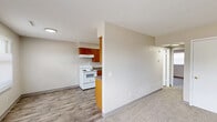 Located at 322 W 65th St in Davenport, Iowa, this single-floor unit offers three bedrooms, one bathroom, and a practical, efficiently organized layout. The galley-style kitchen is well-appointed with warm honey-toned wood cabinetry lining both walls, granite-look countertops, a double-basin sink, and white appliances including a coil-top electric range and refrigerator. Wood-look plank flooring runs through the kitchen and dining area, providing a clean, durable surface. The adjacent living and dining areas offer an open feel with neutral walls and a mix of carpet and plank flooring. Three carpeted bedrooms provide comfortable retreats, with the secondary bedrooms featuring windows with blinds that invite natural light. The primary bedroom includes a walk-in closet with a full hanging rod and shelving above. The bathroom is equipped with a wood-vanity, white countertop, toilet, and a full tub-shower combination. Two hallways connect the rooms efficiently throughout the unit. Neutral tones and clean finishes give the space a move-in ready appearance, while the understated design offers flexibility for personalization.