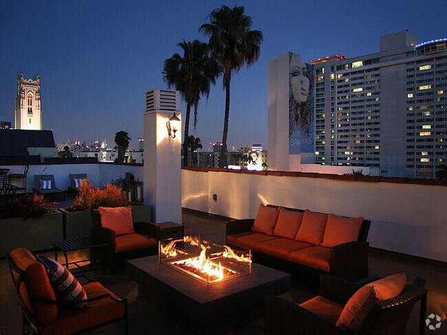 Beautiful nighttime view of rooftop patio with gas firepit and view of Franklin below. - Bonita Terrace