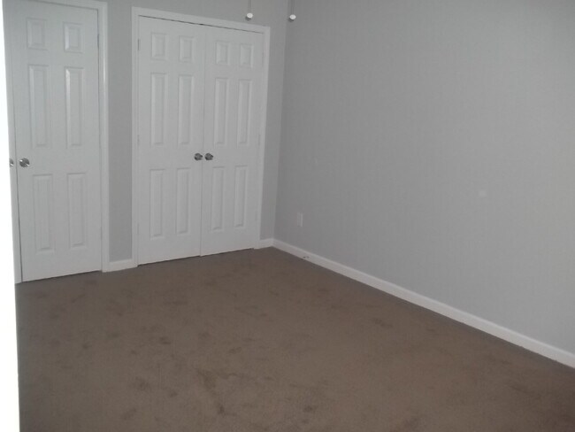 Building Photo - Freshly painted and new flooring in this 4 Bedroom 2 and Half Bath home. Covered front porch with...