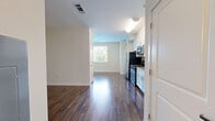 Located at 1 Glover Ave in Norwalk, Connecticut, this well-appointed single-floor unit offers a thoughtfully designed layout that maximizes its compact footprint. Rich, dark hardwood flooring runs throughout the main living area, creating a warm and cohesive aesthetic that complements the clean white walls and bright, open feel of the space.

The kitchen is a standout feature, outfitted with crisp white shaker-style cabinetry reaching toward the ceiling for ample storage, granite countertops, a stainless steel double-basin sink, and a full suite of stainless steel appliances including a gas range, over-the-range microwave, and refrigerator. The kitchen flows seamlessly into the main living area, making the space feel open and connected.

A welcoming entry corridor leads from the front door into the living space, lined with closet storage and finished with the same hardwood flooring, providing a clean transition into the unit.

The bathroom is finished with neutral beige tones, featuring large-format tile flooring, a white vanity with ample cabinet storage, a wide mirror, and a full tub and shower combination enclosed by a curved chrome curtain rod — delivering a clean, functional design.

Overall, the unit presents a modern, move-in-ready aesthetic with quality finishes throughout.