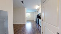 Located at 1 Glover Ave in Norwalk, Connecticut, this well-appointed single-floor unit offers a thoughtfully designed layout that maximizes its compact footprint. Rich, dark hardwood flooring runs throughout the main living area, creating a warm and cohesive aesthetic that complements the clean white walls and bright, open feel of the space.

The kitchen is a standout feature, outfitted with crisp white shaker-style cabinetry reaching toward the ceiling for ample storage, granite countertops, a stainless steel double-basin sink, and a full suite of stainless steel appliances including a gas range, over-the-range microwave, and refrigerator. The kitchen flows seamlessly into the main living area, making the space feel open and connected.

A welcoming entry corridor leads from the front door into the living space, lined with closet storage and finished with the same hardwood flooring, providing a clean transition into the unit.

The bathroom is finished with neutral beige tones, featuring large-format tile flooring, a white vanity with ample cabinet storage, a wide mirror, and a full tub and shower combination enclosed by a curved chrome curtain rod — delivering a clean, functional design.

Overall, the unit presents a modern, move-in-ready aesthetic with quality finishes throughout.