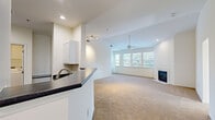 Located at 100 Hunsberger Dr in Limerick, PA, this two-story home offers 3 bedrooms, 2 bathrooms, and a thoughtfully organized layout. The main living level hosts an open-concept kitchen and living room filled with natural light from a large window bank. The kitchen features white cabinetry, dark stone countertops, stainless steel appliances, and light wood-look flooring, with direct access to a dedicated pantry closet. The living area is anchored by a fireplace, ceiling fan, and vaulted ceilings that enhance the sense of openness. The spacious primary bedroom includes vaulted ceilings, plush carpeting, and a generous walk-in closet with wire shelving. Two additional carpeted bedrooms each offer ample closet space and natural light. The bathrooms are clean and functional, with the primary bath featuring a dual-sink vanity with white cabinetry and wood-look flooring. A dedicated laundry area with overhead wire shelving adds convenience. The staircase connects the main living floor to the lower level, which includes a large attached garage with an automatic opener, offering substantial storage and parking capacity. Four closets throughout the home provide excellent storage solutions.