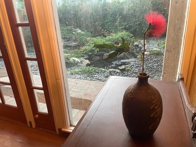 One can enjoy the cascades of the backyard from the living room. - 11449 Woodbine St