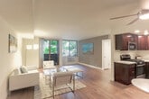 Located at Del Medio Ave in Mountain View, CA, this 2-bedroom, 1-bathroom residence delivers a thoughtfully organized single-floor layout with clean, modern finishes throughout. The open living room is a standout feature, showcasing wide-plank hardwood flooring, neutral-toned walls, and large sliding glass doors that flood the space with natural light and provide direct access to a private balcony with pleasant outdoor views. The adjoining dining area flows seamlessly into a well-appointed kitchen featuring rich dark wood cabinetry, white countertops, stainless steel appliances including a gas range, dishwasher, and refrigerator, complemented by the same wood flooring for a cohesive feel. The spacious primary bedroom offers mirrored sliding closet doors and a bright, airy atmosphere, while the second bedroom benefits from large windows with views of mature trees, providing a serene retreat. A hallway connects the living areas to three closets and a utility room, ensuring ample storage. The full bathroom is finished with dark wood vanity cabinetry, a white countertop, and a tub-shower combo with sliding glass doors. The overall ambiance is bright, clean, and welcoming, well-suited for comfortable everyday living in the heart of Silicon Valley.