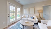 This single-floor residence at 243 Talcottville Rd in Vernon Rockville, Connecticut, offers a thoughtfully designed layout with modern finishes and a cohesive contemporary aesthetic. Light-toned hardwood-style flooring flows consistently throughout the space, creating a unified and inviting atmosphere.

The kitchen serves as a functional centerpiece, featuring crisp white shaker cabinetry extending to the ceiling, granite countertops, stainless steel appliances, and a central island with seating — illuminated by elegant pendant lighting. The adjacent living area is bright and airy, with natural light streaming through large windows and French doors that open to an outdoor view of open green space, enhancing the sense of connection to the outdoors.

The bedrooms are well-proportioned and filled with natural light from generously sized windows, each offering a calm, neutral palette and hardwood-style flooring. The layout includes two bathrooms: one featuring a shower-tub combination with a dark-cabineted vanity and white countertop, and a second with a walk-in shower stall and matching vanity. Both bathrooms maintain a clean, modern aesthetic with light flooring and bright white fixtures throughout.