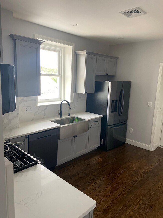 brand new kitchen with stainless black stainless steel appliances. Hardwood floors throughout! - 471 Eastern Ave