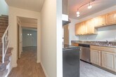 Located in Virginia Beach, VA, this two-story home offers a well-organized layout across two levels connected by a wood-banistered staircase. The main living areas feature warm wood-look hardwood flooring throughout, creating a cohesive and inviting atmosphere. The open living and dining areas are generously sized, with neutral walls, ceiling vents, and ample room for flexible furniture arrangements.

The kitchen is equipped with honey-toned wood cabinetry offering extensive upper and lower storage, dark granite-style countertops, a double basin sink, a stainless steel dishwasher, and a microwave — providing a functional and well-appointed cooking space. Adjacent to the entryway is a convenient half bath, accessible just inside the front door.

The bedrooms are carpeted for comfort and include spacious closets with built-in shelving, offering practical storage solutions. Natural light filters in through slatted blinds in the bedrooms, enhancing the bright and airy feel. The full bathroom features a full-size tub and shower combo with clean white fixtures and wood-look tile flooring.

The entry foyer is finished with light wood-look flooring and provides easy access to the main living spaces. Overall, this home presents a clean, functional design suitable for everyday living in a residential Virginia Beach neighborhood.