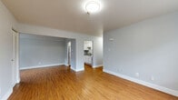 Located at 14 N Manning Blvd in Albany, NY, this 2-bedroom, 1-bathroom unit offers a well-organized single-floor layout with consistent warm-toned hardwood flooring throughout. The open living room is bright and airy, featuring neutral light-gray walls and a seamless connection to the adjacent bedroom and kitchen areas, creating a spacious and cohesive feel.

The kitchen is well-appointed with crisp white shaker-style cabinetry, granite countertops, a stainless steel sink, and white appliances including a full-size refrigerator and range. The hardwood floors carry through, adding warmth and continuity.

The primary bedroom offers a comfortable footprint with a window overlooking the outdoors, a baseboard heating unit, and access to a dedicated closet. The second bedroom mirrors the clean aesthetic, also featuring hardwood floors, neutral gray walls, and a window that invites natural light and outdoor views.

The bathroom is clean and functional, finished with white subway tile surrounding a full soaking tub and shower combination. A hallway connects the rooms efficiently, maintaining a logical and practical flow throughout the unit. Overall, the space presents a clean, move-in-ready aesthetic with consistent finishes and a functional layout well-suited for everyday living.