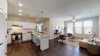 Located on De Morada Drive in Odessa, Texas, this single-story residence offers a thoughtfully designed open-concept layout that seamlessly connects the kitchen, dining, and living areas. Dark hardwood-style flooring flows throughout the main living spaces, providing a warm and cohesive aesthetic.

The kitchen is well-appointed with white shaker cabinetry, granite countertops, a subway tile backsplash, stainless steel appliances including a range and dishwasher, and a center island with pendant lighting overhead. The adjacent dining area provides an intimate space near the entryway, while the living room benefits from multiple windows that invite natural light and a ceiling fan for year-round comfort.

The bedrooms are carpeted for added comfort, each featuring ceiling fans and windows with blinds. The primary bedroom is generously sized, while the secondary bedroom offers a cozy, well-lit retreat.

Both bathrooms are finished with tile-surround tub and shower combinations, dark hardwood-style flooring, and clean, neutral tones. One bathroom includes grab bars, adding a practical accessibility feature. Overall, the unit presents a clean, modern aesthetic with consistent finishes throughout.
