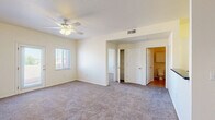 Located on El Paseo Road in Las Cruces, New Mexico, this two-bedroom, one-bathroom residence offers a practical and well-organized single-floor layout. The open living area flows seamlessly from the kitchen, which features white cabinetry, a raised breakfast bar with a dark countertop, and built-in appliances including a microwave and range. Tile flooring anchors the kitchen and entry areas, while plush carpet extends throughout the living spaces and bedrooms, adding warmth underfoot.

The generously sized primary bedroom is a standout feature, offering ample room for comfortable living. It includes a ceiling fan with light fixture, a walk-in closet, private access to the bathroom, and a door leading to an outdoor balcony area. Natural light fills the room through multiple windows with views of the surrounding Las Cruces landscape. The second bedroom is equally well-appointed, also featuring carpet, a ceiling fan, and a window with natural light.

The full bathroom is finished with tile flooring, a wide vanity topped with a dark countertop, white cabinetry, a large mirror, and a shower-tub combination with sliding glass doors. A dedicated in-unit laundry area with a full-size washer and dryer adds everyday convenience. This residence combines functional design with comfortable finishes throughout.