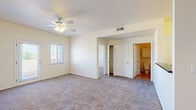 Located on El Paseo Road in Las Cruces, New Mexico, this two-bedroom, one-bathroom residence offers a practical and well-organized single-floor layout. The open living area flows seamlessly from the kitchen, which features white cabinetry, a raised breakfast bar with a dark countertop, and built-in appliances including a microwave and range. Tile flooring anchors the kitchen and entry areas, while plush carpet extends throughout the living spaces and bedrooms, adding warmth underfoot.

The generously sized primary bedroom is a standout feature, offering ample room for comfortable living. It includes a ceiling fan with light fixture, a walk-in closet, private access to the bathroom, and a door leading to an outdoor balcony area. Natural light fills the room through multiple windows with views of the surrounding Las Cruces landscape. The second bedroom is equally well-appointed, also featuring carpet, a ceiling fan, and a window with natural light.

The full bathroom is finished with tile flooring, a wide vanity topped with a dark countertop, white cabinetry, a large mirror, and a shower-tub combination with sliding glass doors. A dedicated in-unit laundry area with a full-size washer and dryer adds everyday convenience. This residence combines functional design with comfortable finishes throughout.