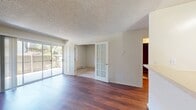 This 510 square foot apartment in Mountain View offers a thoughtful blend of comfort and functionality. The single-story layout comprises one bedroom, two bathrooms, and an open-concept living area. Rich hardwood flooring extends throughout most of the space, adding warmth and elegance.

The living room is spacious and bright, featuring a large sliding glass door that leads to an outdoor area, allowing natural light to flood the interior. French doors separate this space from an adjacent room, offering flexibility in use.

The kitchen, while compact, is well-equipped with light wood cabinetry, ample counter space, and modern appliances. It opens to the living area, promoting a sense of spaciousness and facilitating easy entertainment.

The bedroom, measuring 110 square feet, offers a cozy retreat with carpeted flooring and a window for natural light. Two bathrooms provide convenience, with at least one featuring a shower/tub combination.

Additional features include a separate closet for storage and textured ceilings throughout. The apartment's layout, as seen in the 3D model, is efficiently designed to maximize the use of space. Located at 575 S Rengstorff Ave, this apartment offers a comfortable living solution in the heart of Mountain View.