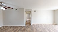 Located on Greenhaven Drive in Sacramento, CA, this single-story, 3-bedroom, 2-bathroom home offers a well-organized and functional layout. The living room serves as the central gathering space, featuring rich wood-look flooring, a tile-surround fireplace with a white mantel, and large sliding glass doors that flood the room with natural light and provide access to the outdoors. The kitchen is well-appointed with white shaker-style cabinetry, dark countertops, stainless steel appliances including a range, microwave, and dishwasher, and a window above the sink for added brightness. A central hallway connects the three bedrooms, each finished with neutral carpet and windows that bring in natural light. The spacious primary bedroom offers a comfortable retreat with ample room and closet access. Two full bathrooms echo the home's consistent design palette, featuring white cabinetry, dark countertops, wood-look flooring, and tub-shower combinations. Two dedicated closets provide additional storage. Neutral gray walls, clean white trim, and cohesive finishes throughout create a calm and move-in-ready atmosphere across the entire home.