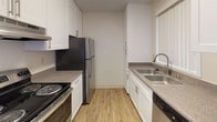 Located at 3511–3549 Valley Rd in Bonita, this single-floor unit offers a clean, neutral palette throughout, designed to maximize natural light and functionality. The living area is generously proportioned, featuring plush wall-to-wall carpeting, a textured ceiling, and a wall-mounted HVAC unit. A sliding glass door with vertical blinds opens to a private balcony with outdoor views, while an adjacent window further enhances the bright, airy atmosphere. A ceiling fan with a light fixture in a secondary living or dining area adds comfort and a sense of warmth.

The galley-style kitchen is efficiently laid out with white cabinetry, granite-style countertops, wood-look flooring, a double stainless steel sink, a stainless steel refrigerator, an electric range, and a dishwasher. Ample cabinet storage lines both sides of the kitchen, making the space highly practical.

The bedrooms are carpeted and well-lit, each featuring vertical blinds and multiple windows that allow natural light to pour in. The two bathrooms mirror each other in design, both offering white vanity cabinetry, granite-style countertops, large mirrors, wood-look flooring, and brushed nickel fixtures. One bathroom includes a shower-tub combination. The overall ambiance is clean, functional, and move-in ready.