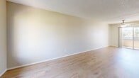 Located at 3935 La Sierra Ave in Riverside, CA, this single-floor, one-bedroom, two-bathroom unit offers a well-organized layout across a compact and efficient floor plan. The living and dining areas are open and connected, featuring light wood-style flooring, neutral beige walls, a textured ceiling, and a ceiling fan that enhances airflow throughout. A wall-mounted AC unit and a sliding glass door lead to a private balcony, allowing natural light to fill the space and offering views of the surrounding neighborhood.

The galley-style kitchen is thoughtfully designed with white cabinetry lining both walls, light stone-finish countertops, a deep sink, and white appliances including a gas range, dishwasher, and refrigerator. A skylight-style overhead fixture brightens the workspace.

The bedroom is carpeted for comfort, equipped with a ceiling fan and a natural window view of mature trees. Mirrored sliding closet doors add depth to the room, and the unit includes a total of three closets for generous storage.

Both bathrooms are clean and functional, featuring a tub-shower combination with white surround tile and chrome fixtures. The overall aesthetic is bright, neutral, and move-in ready, making this Riverside unit a practical and comfortable living space.