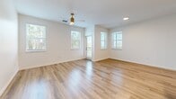 Located at 14520 Avalon Rd in Winter Garden, FL, this single-story, 3-bedroom, 2-bathroom home offers a clean, modern aesthetic throughout. Light wood-look flooring flows seamlessly across the entire living space, complementing the crisp white walls and bright, airy atmosphere created by abundant natural light from multiple windows.

The open-concept kitchen, dining, and living area serves as the heart of the home. The kitchen is well-appointed with granite countertops, white shaker-style cabinetry accented by gold hardware, a subway tile backsplash, a central island with a double sink and gold-tone faucet, and a full suite of stainless steel appliances including a refrigerator, range, and built-in microwave.

The spacious primary bedroom features a ceiling fan, multiple windows with outdoor views, and access to a private en suite bathroom with a glass-enclosed walk-in shower and granite vanity. The second full bathroom includes a tiled tub-shower combination and marble-style tile flooring. The two additional bedrooms are well-sized, each with a ceiling fan and windows offering natural views of the surrounding landscape. The home also includes a dedicated laundry room, multiple closets, and a balcony, rounding out a highly functional and stylish living space.