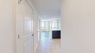 This contemporary apartment offers a spacious 1420 square feet of living space across two floors. The lower level spans 920 square feet, while the upper floor provides an additional 500 square feet. The layout includes two bedrooms, with the primary bedroom boasting a generous 170 square feet.

The heart of the home is the open-concept living area, which seamlessly integrates the kitchen and living room. The gourmet kitchen features sleek dark wood cabinetry, stainless steel appliances, and a striking herringbone tile backsplash. A large kitchen island with a quartz countertop offers additional prep space and casual dining options.

Throughout the apartment, wood-look flooring adds warmth and durability. Large windows in every room flood the space with natural light and frame urban views. The private balcony extends the living space outdoors, perfect for enjoying the cityscape.

The bathrooms are thoughtfully designed with modern fixtures, including pedestal sinks and tiled shower/tub combinations. The apartment's three full bathrooms ensure convenience for residents and guests alike.

With its blend of style, comfort, and urban sophistication, this apartment offers a premium living experience in the heart of the city.