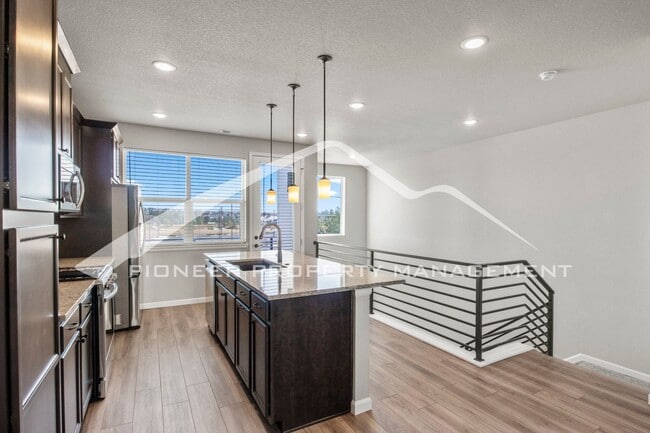 Building Photo - Contemporary Townhome in the Vibrant Interquest Low Maintenance Community with 2 car garage, Wash...