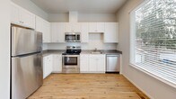 Located at 2920 Falk Rd in Vancouver, WA, this three-bedroom, two-bathroom home is thoughtfully arranged across three floors, offering a functional and comfortable layout. The entry level provides a welcoming entrance that sets the tone for the clean, neutral aesthetic found throughout the home.

The kitchen is a standout feature, equipped with stainless steel appliances including a refrigerator, range, microwave, and dishwasher. White shaker-style cabinetry, grey countertops, and warm hardwood-style flooring give the kitchen a bright, modern feel, complemented by a window that brings in natural light.

The bedrooms are carpeted and well-lit, with multiple windows offering outdoor views of the surrounding neighborhood and mature trees. Sliding double-door closets provide ample storage in the bedrooms. The primary bedroom offers a comfortable, private retreat. Two hallways connect the spaces across the upper floors, and four closets throughout the home ensure generous storage.

The two bathrooms are finished with hardwood-style flooring and clean white fixtures — one features a walk-in shower with sliding glass doors, while the other includes a full soaking tub. A dedicated laundry area and a bonus room add further versatility. Recessed lighting in the hallways enhances the home's overall bright and airy atmosphere.