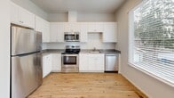 Located at 2920 Falk Rd in Vancouver, WA, this three-bedroom, two-bathroom home is thoughtfully arranged across three floors, offering a functional and comfortable layout. The entry level provides a welcoming entrance that sets the tone for the clean, neutral aesthetic found throughout the home.

The kitchen is a standout feature, equipped with stainless steel appliances including a refrigerator, range, microwave, and dishwasher. White shaker-style cabinetry, grey countertops, and warm hardwood-style flooring give the kitchen a bright, modern feel, complemented by a window that brings in natural light.

The bedrooms are carpeted and well-lit, with multiple windows offering outdoor views of the surrounding neighborhood and mature trees. Sliding double-door closets provide ample storage in the bedrooms. The primary bedroom offers a comfortable, private retreat. Two hallways connect the spaces across the upper floors, and four closets throughout the home ensure generous storage.

The two bathrooms are finished with hardwood-style flooring and clean white fixtures — one features a walk-in shower with sliding glass doors, while the other includes a full soaking tub. A dedicated laundry area and a bonus room add further versatility. Recessed lighting in the hallways enhances the home's overall bright and airy atmosphere.