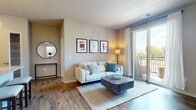 Located at 507 W Verona Ave in Verona, Wisconsin, this thoughtfully designed single-floor residence offers a seamless open-concept layout that connects the kitchen, dining, and living areas into one cohesive, light-filled space. Warm wood-style flooring runs throughout the main living areas, complementing the neutral color palette and creating an inviting atmosphere throughout.

The kitchen is a standout feature, showcasing rich dark cabinetry, granite countertops, stainless steel appliances, and a central island with an integrated sink and bar seating — ideal for both everyday meals and entertaining. Recessed and pendant lighting add a polished finishing touch.

The living room is bright and welcoming, anchored by sliding glass doors that open to a private balcony, allowing abundant natural light to flow in. Two well-proportioned bedrooms offer plush carpeting, natural window light, and ceiling fans for comfort. The bathrooms continue the consistent design language with dark cabinetry, granite-topped vanities, and wood-style flooring. One bathroom features a combination tub and shower, while the other includes a walk-in shower. Additional built-in shelving and generous closet space add to the unit's practical appeal throughout.