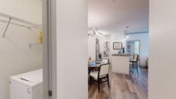 Located at 5400 Chenonceau Blvd in Little Rock, AR, this single-floor, 3-bedroom, 2-bathroom residence offers a thoughtfully designed layout that maximizes comfort and functionality. The open-concept living, dining, and kitchen area creates a cohesive, flowing space anchored by wood-look flooring throughout. The living room features crown molding, a ceiling fan, and large windows that invite natural light and outdoor views. The dining area is defined by an elegant chandelier overhead, adding a refined touch to everyday meals. The kitchen is equipped with rich dark wood cabinetry, stainless steel appliances, granite countertops, a breakfast bar, and track lighting, offering both style and practicality. The primary bedroom is a serene retreat with plush carpet, a ceiling fan, and a window framing outdoor greenery. It connects to a walk-in closet with multi-tier wire shelving for generous storage. The bathrooms are finished with tile flooring, dark wood vanities, and well-lit mirrors. Two additional bedrooms provide flexible space for guests or a home office. Throughout the residence, crisp white walls and clean architectural lines create a bright, welcoming ambiance suited for modern living.