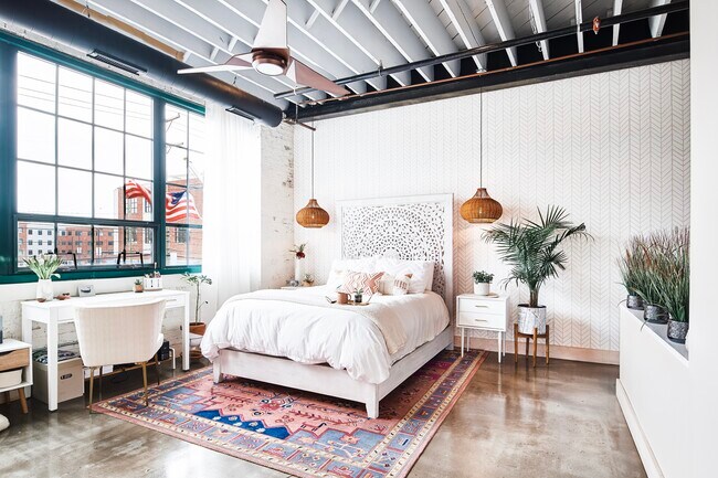 Master Bedroom with beautiful wallpaper, exposed brick, pendant lights - 2987 Franklin St