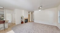 This single-story, 3-bedroom, 2-bathroom home in Bakersfield, CA offers a well-organized and functional layout. The open-concept living, dining, and kitchen area forms the heart of the home, featuring plush carpeting, a ceiling fan, and a tile-surround fireplace that anchors the living space. Natural light flows in through windows with blinds, creating a bright and welcoming atmosphere. The kitchen is well-appointed with white cabinetry, granite countertops, stainless steel appliances including a gas range, microwave, and refrigerator, and tile flooring. A pantry provides additional storage convenience. The primary bedroom is generously sized with a ceiling fan, carpet, and a window overlooking the outdoors. Additional bedrooms are equally comfortable, each with carpet and ceiling fans. The bathrooms feature tile flooring, white vanity cabinetry, and granite countertops. A dedicated laundry room houses a full-size washer and dryer with overhead cabinetry. Multiple closets throughout provide ample storage. The attached garage offers additional utility space. The home's neutral color palette and cohesive finishes create a clean, move-in-ready environment throughout.