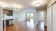 Located at 550 Park Ave W in Chatham-Kent, Ontario, this well-appointed 2-bedroom, 2-bathroom unit offers a thoughtfully designed single-floor layout with a warm, modern aesthetic throughout. Rich hardwood-style flooring runs continuously through the living areas and bedrooms, complemented by neutral-toned walls that create a bright and welcoming ambiance.

The kitchen is a standout feature, showcasing rich dark-stained cabinetry with sleek hardware, light granite countertops, a classic white subway tile backsplash, and a full suite of stainless steel appliances including a refrigerator, range, over-the-range microwave, and dishwasher. The generous primary bedroom benefits from natural light through a large window with outdoor views, and includes access to a walk-in closet fitted with wire shelving for organized storage. The second bedroom is equally comfortable and versatile.

The two bathrooms are clean and functional — one featuring a full soaker tub with shower surround, and the other a walk-in shower stall with built-in corner shelving. A dedicated laundry room with full-size washer and dryer units, along with upper cabinetry for additional storage, adds everyday convenience. The overall design balances practicality with modern finishes, making this a comfortable and functional home.