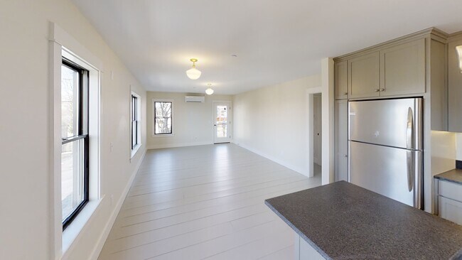 Large, open living and dining space off of the kitchen, with access to the outdoor covered porch - 88 Walnut St