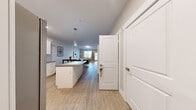 Located at 1105 Red Apple Rd in Wenatchee, Washington, this single-floor residence offers a thoughtfully designed open-concept layout with a clean, modern aesthetic. Light wood-look flooring flows seamlessly throughout the unit, creating a cohesive and airy atmosphere.

The kitchen is a standout feature, appointed with crisp white shaker-style cabinetry, granite-look countertops, stainless steel appliances — including a range, microwave, and dishwasher — and a central island with pendant lighting overhead. The kitchen opens directly into the dining and living areas, making the space ideal for everyday living and entertaining.

The living area is bright and welcoming, with large windows that invite natural light and provide views of the surrounding neighborhood. Each bedroom is finished in warm neutral tones with light flooring and ample closet space, including a double-door closet configuration in one of the rooms.

The bathrooms are finished with white vanity cabinetry, stone-look countertops, brushed nickel hardware, and a full tub-and-shower combination. Accessible grab bars are present in one bathroom, highlighting thoughtful design considerations. A wall-mounted HVAC unit provides climate control throughout the home. The overall palette of soft grays, whites, and warm neutrals lends a calm, contemporary feel to the entire space.