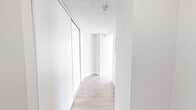 Located at 200–230 Denistoun Street in Welland, Ontario, this one-bedroom, one-bathroom unit offers a thoughtfully laid-out single-floor plan with a clean, bright aesthetic throughout. Light wood-style luxury vinyl flooring flows continuously across the entire space, complemented by crisp white walls and textured ceilings that give each room a fresh, well-maintained feel.

The open-concept living, dining, and kitchen area forms the heart of the unit, providing a generous, versatile space ideal for everyday living. Large windows dressed with vertical blinds invite ample natural light into the living area, and a baseboard heating unit runs along the exterior wall. The kitchen is efficiently positioned and connects seamlessly to the main living space.

The bedroom is a comfortable, well-sized room featuring a built-in sliding-door closet, a window with an outdoor view of surrounding greenery, and the same warm flooring found throughout. A hallway with an additional sliding-door storage closet connects the bedroom to the rest of the unit, adding practical storage solutions.

The bathroom is clean and functional, featuring a full tub-and-shower surround with chrome fixtures. Overall, the unit presents a light, neutral palette and a practical layout suited for comfortable, everyday living.