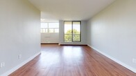Located at 2000 Main St W in Hamilton, Ontario, this 2-bedroom unit offers a practical and comfortable layout across a single floor. Warm hardwood-style flooring runs throughout the space, lending a cohesive and inviting feel to every room.

The galley-style kitchen is efficiently designed, featuring white cabinetry, a subway tile backsplash, a stainless steel sink, and full-sized appliances including a refrigerator and stove. A window at the end of the kitchen draws in natural light and connects the cooking area to the rest of the unit.

The living room is generously proportioned, with large floor-to-ceiling windows and an additional window that frame lush outdoor greenery, filling the room with natural light. Baseboard heating runs along the perimeter, ensuring year-round comfort.

Both bedrooms are well-sized, with the primary bedroom offering a spacious sliding-door closet for ample storage. Each bedroom features windows that bring in natural light, neutral-toned walls, and the same warm flooring found throughout the unit.

The layout flows intuitively, connecting the kitchen, living area, and bedrooms in a straightforward and functional arrangement. Clean white walls, consistent finishes, and bright windows throughout contribute to a bright, move-in-ready atmosphere.