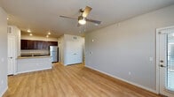 This single-story residence in Colorado Springs, Colorado offers a well-designed, open-concept layout that seamlessly connects the living area and kitchen. The living space is finished with warm light wood-tone flooring and neutral gray walls, creating a clean and contemporary atmosphere. A ceiling fan with an integrated light fixture provides both airflow and ambient lighting, while multiple windows along one wall allow natural light to fill the room and offer views of the surrounding neighborhood. A double-door closet in the living area provides convenient storage.

The kitchen is a functional and stylish centerpiece of the unit, featuring rich dark espresso cabinetry with sleek hardware and light granite countertops throughout. A peninsula with an undermount double sink and built-in dishwasher separates the kitchen from the living area, offering additional prep space and a casual dining option. Stainless steel appliances, including a refrigerator, electric range, and over-the-range microwave, complete the kitchen. Recessed lighting and a pantry area add further practicality.

The bedroom is carpeted and offers a quiet, comfortable retreat. The bathroom includes a dark wood vanity with a granite countertop, light wood-tone flooring, and a tub-shower combination, maintaining the consistent design aesthetic found throughout the home.