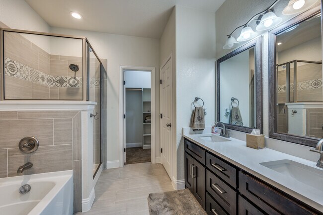 Bathroom with framed mirrors, double sink/vanity, separate shower and bathtub, walk-in closet - 3032 James Ave