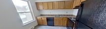 This 900 square foot apartment in Latham, NY offers a comfortable living space with two bedrooms and two bathrooms. The unit features a mix of modern updates and traditional elements. The living area showcases newly installed grey wood-look flooring, creating a contemporary aesthetic. Large windows in the living room and bedrooms flood the space with natural light and offer views of the surrounding area, including a winter landscape.

The kitchen is equipped with light wood cabinetry, providing ample storage space, and features a granite-look countertop with a built-in sink. A black dishwasher adds a modern touch to the space. The bathrooms have been updated with new vanities and fixtures, presenting a clean and fresh appearance.

The primary bedroom, measuring 190 square feet, offers generous space for a comfortable retreat. Both bedrooms are carpeted for added comfort. The apartment includes a balcony, accessible through sliding glass doors, offering an outdoor space for relaxation or entertaining.

The unit's layout is efficient, with a hallway connecting the various rooms. Baseboard heating units are visible in several rooms, ensuring comfort during colder months. The overall design of the apartment emphasizes openness and light, creating a welcoming atmosphere throughout the 900 square foot space.
