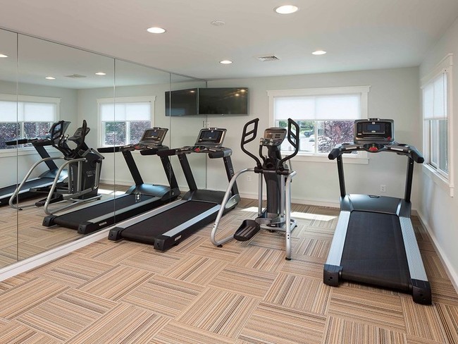 Fitness center at Yardley Crossing with two treadmills and an elliptical machine - Yardley Crossing Luxury Apt and Townhomes