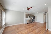 Located at 1717 Religious St in New Orleans, Louisiana, this efficiently designed single-floor unit offers a thoughtful layout that maximizes every square foot. The open-plan kitchen and living area serves as the heart of the space, featuring warm hardwood-style flooring throughout and a ceiling fan that adds both function and style. The kitchen is outfitted with grey shaker-style cabinetry, granite-look countertops, and a full suite of stainless steel appliances, including a range, microwave, dishwasher, and refrigerator — providing a modern, cohesive aesthetic.

A standout architectural feature is the exposed brick accent wall in the living area, which adds historic New Orleans character and texture to the otherwise clean, contemporary interior. Natural light filters in through windows framed by the brick, enhancing the warm ambiance of the space.

The hallway connects the main living area to the bathroom and includes a stacked in-unit washer and dryer — a convenient and practical amenity. The bathroom continues the consistent design language with grey cabinetry, granite-look countertops, a vanity mirror, and a shower-tub combination. Recessed lighting and neutral grey walls throughout contribute to a bright, modern feel.