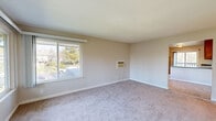 Located at 601 River Glen Dr in Napa, CA, this two-bedroom, one-bathroom residence offers a practical and comfortable single-floor layout. The living room is bright and welcoming, featuring neutral-toned carpet, a large picture window that draws in natural light and frames views of the surrounding greenery, and a front entry door. A sliding glass door in one of the rooms opens to a private balcony overlooking lush outdoor scenery, adding an inviting indoor-outdoor connection.

The kitchen is well-appointed with rich, warm-toned wood cabinetry extending to the ceiling, stainless steel appliances including a range and refrigerator, dark countertops, and tile flooring. A peninsula provides additional prep space, while multiple windows and a sliding door ensure the kitchen remains bright and airy. A pantry offers extra storage convenience.

Both bedrooms are generously proportioned, with soft carpet flooring and neutral walls. The primary bedroom includes a closet and a window unit for climate control. The bathroom features tile flooring, a full tub-shower combo, and a white vanity with ample storage. Three closets throughout the home provide excellent storage. A hallway connects the rooms, creating a cohesive and functional floor plan throughout.