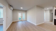 Located at 1866 Lincoln Ave in Calistoga, California, this single-floor, 3-bedroom, 2-bathroom home offers a thoughtfully designed layout with a clean, contemporary aesthetic. Light wood-tone flooring runs throughout, complementing neutral gray-beige walls and crisp white trim to create a bright, cohesive interior.

The open living area connects seamlessly to the kitchen and features French-style glass doors that lead to a private balcony, allowing natural light to pour in and offering pleasant outdoor views. A wall-mounted mini-split system provides efficient climate control.

The kitchen is well-appointed with rich dark espresso shaker-style cabinetry, white countertops, a stainless steel sink, and a full suite of stainless steel appliances including a range, microwave, dishwasher, and refrigerator — making it both functional and visually striking.

The three bedrooms are comfortably proportioned, with the primary bedroom featuring direct access to a bathroom and a dedicated closet with built-in rod storage. The bedrooms include windows with vertical blinds that frame views of the surrounding greenery. The two bathrooms are finished cleanly, one featuring a full tub-shower combination with white tile surround.

A central hallway connects the living spaces efficiently, rounding out this well-organized, move-in-ready home in the heart of Napa Valley wine country.