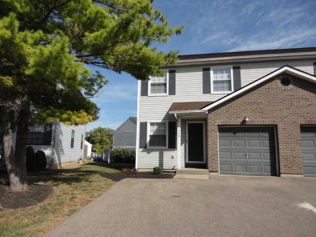 Left side of a duplex building with one car attached garage with opener - 7960 Bobtail Ct