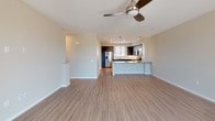 Located at 1630 Paseo Monti in Chula Vista, this contemporary multi-story residence spans three floors and showcases a thoughtfully designed interior with modern finishes throughout. The open-concept main living area features wood-look flooring, recessed lighting, and a ceiling fan, flowing seamlessly into the kitchen and dining space. The kitchen is a standout feature, equipped with stainless steel appliances including a gas range, built-in microwave, and refrigerator. Dark espresso cabinetry pairs elegantly with light quartz countertops and a striking marble-look tile backsplash, while pendant lighting adds a refined touch above the peninsula.

Bedrooms are carpeted and well-lit by multiple windows with blinds, with the primary suite offering sliding glass door access to a private outdoor space with expansive views of the Chula Vista landscape. The primary bathroom includes a dual-sink vanity with dark cabinetry, a large framed mirror, a glass-enclosed shower, and a spacious walk-in closet with built-in shelving. A secondary bathroom features a combination tub and shower. A dedicated laundry area accommodates a full-size washer and dryer, adding everyday convenience to this well-appointed home.