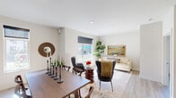 Located at 6020 E Fourth Ave in Spokane Valley, WA, this 2-bedroom, 2-bathroom residence offers a thoughtfully designed single-floor layout that maximizes every inch of its well-utilized footprint. Light wood-style flooring runs throughout, lending a clean, cohesive aesthetic across all areas.

The open-concept living, dining, and kitchen area serves as the heart of the home. The living room receives generous natural light through large windows with roller shades, creating a bright and welcoming atmosphere. The dining area accommodates a full-sized table and flows seamlessly into the kitchen, which features white cabinetry, quartz-style countertops, stainless steel appliances, and a striking gray tile backsplash with open shelving for added character.

The primary bedroom offers a sizable closet and a large sliding glass door that opens to an outdoor view, filling the room with sunlight. The second bedroom is equally comfortable, featuring a full closet and its own access to natural light. Both bathrooms are clean and functional, with one featuring a full tub-shower combination.

A dedicated in-unit laundry closet with a modern washer provides added convenience. Three closets throughout the home ensure ample storage. The overall design is fresh, modern, and move-in ready.
