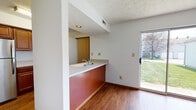 Located at 6803 Brandt Pike in Huber Heights, Ohio, this two-story home offers a practical and comfortable layout across two well-defined levels. The main living area features a tiled fireplace with a wood surround as a central focal point, complemented by hardwood-style flooring and a staircase with a wood railing leading to the upper level. A sliding glass door brings in natural light and provides direct access to the outdoors. The kitchen is equipped with warm-toned wood cabinetry, speckled light countertops, and stainless steel appliances including a refrigerator, range, and over-the-range microwave. A pass-through counter with a sink connects the kitchen to the adjacent dining or living area, enhancing the open feel of the main floor. A half bathroom on the main level includes a wood vanity with a white countertop and hardwood-style flooring. Upstairs, the carpeted bedrooms offer closet space and natural light through double windows. Two full bathrooms serve the upper level, each featuring a tub-shower combo and a vanity with under-sink storage. The home also includes an attached garage with an automatic opener, offering additional utility and storage potential.