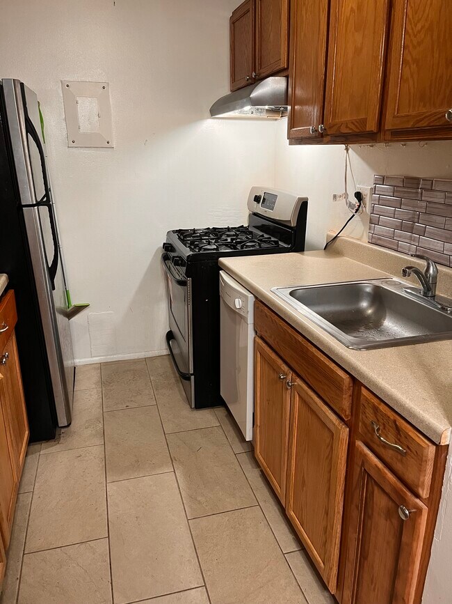 Kitchen with brand new stainless steel appliances - 5400 85th Ave